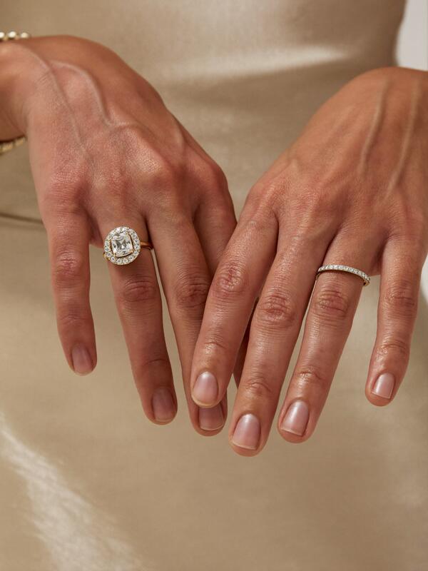 Model wearing a halo ring and eternity band