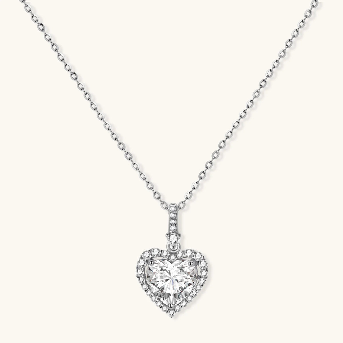 Heart-shaped moissanite pendant in a sterling silver setting on a fine chain