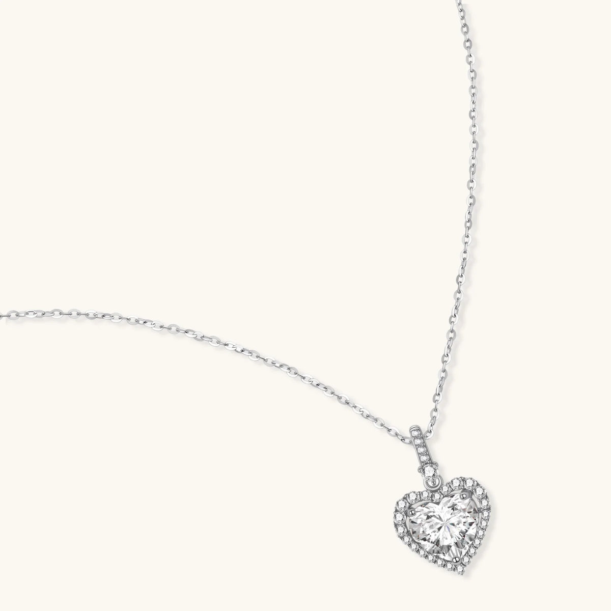 Heart-shaped moissanite pendant in a sterling silver setting on a fine chain