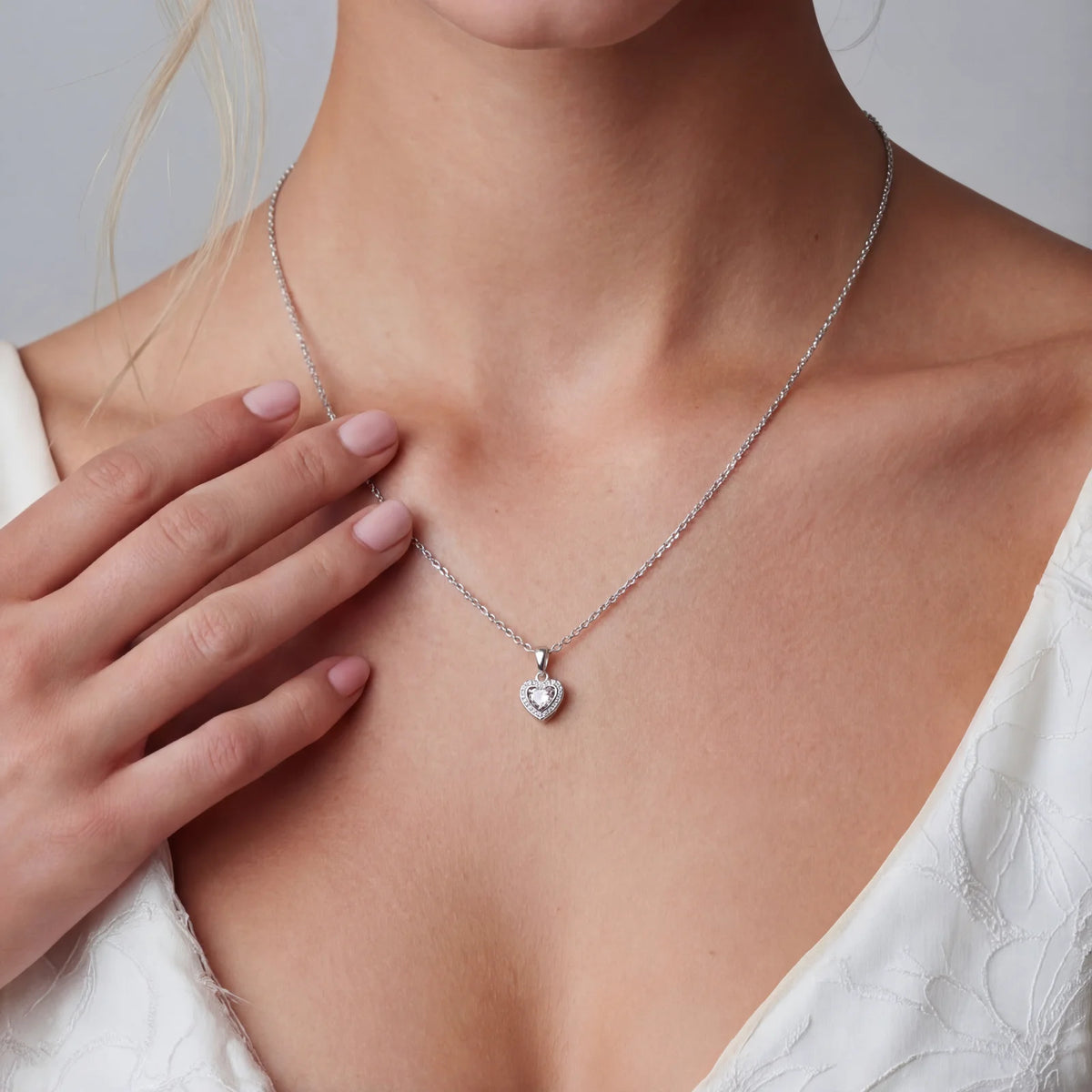 Heart-shaped moissanite pendant in a sterling silver setting on a fine chain