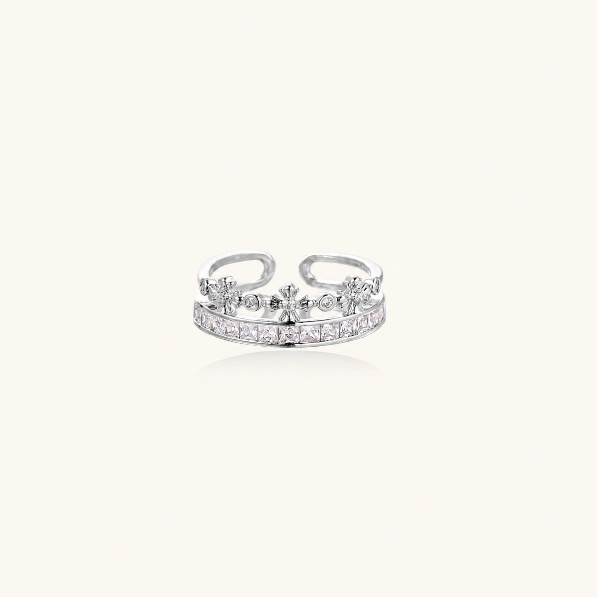 Royal Crown Ring: crown-shaped ring with princess-cut zirconia and small floral details across two bands