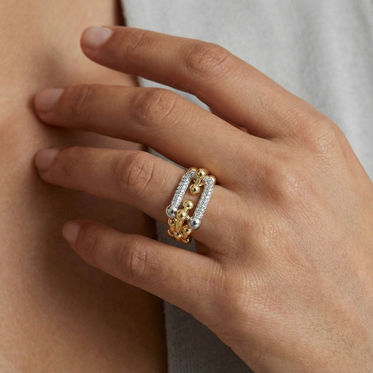 Chain Link Power Ring: polished spheres and sparkling cubic zirconia across three joined bands