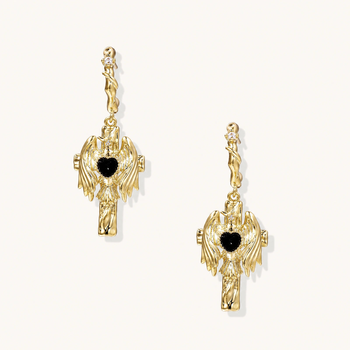 Angel Wings Drop Earrings: Two sculpted wings hold a black heart-shaped stone in these drop earrings
