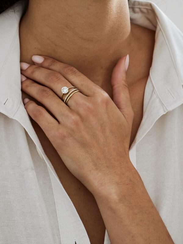 Model wearing a solitaire ring and stacking bands