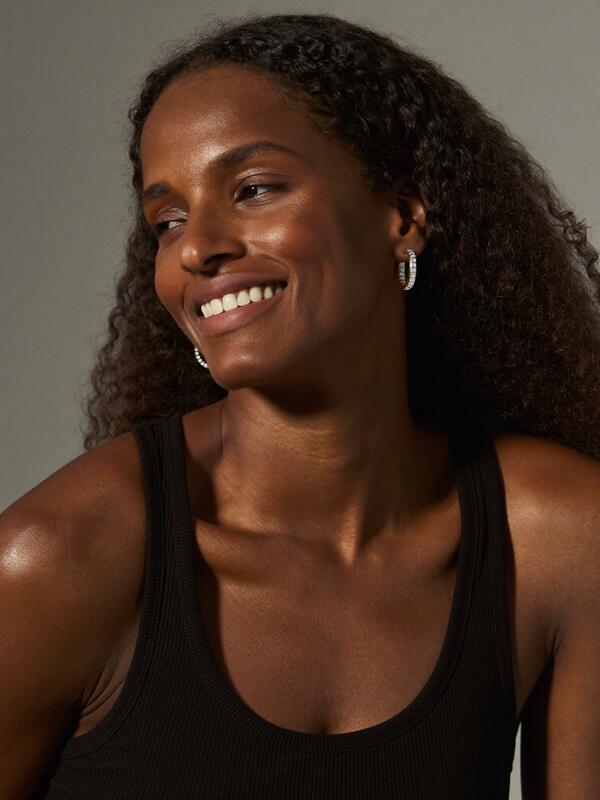 Model wearing sparkling hoop earrings